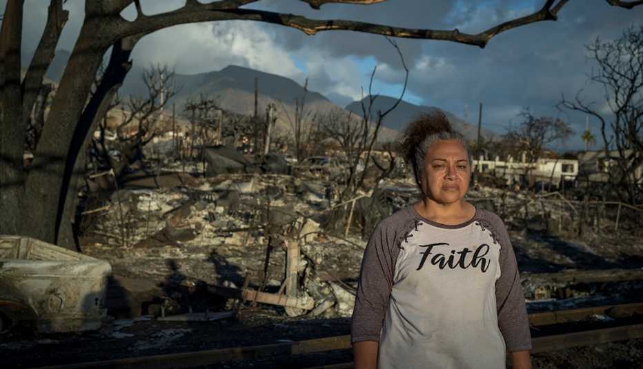 etina hingano stands among the wreckage of lahaina on maui in late august twenty twenty three