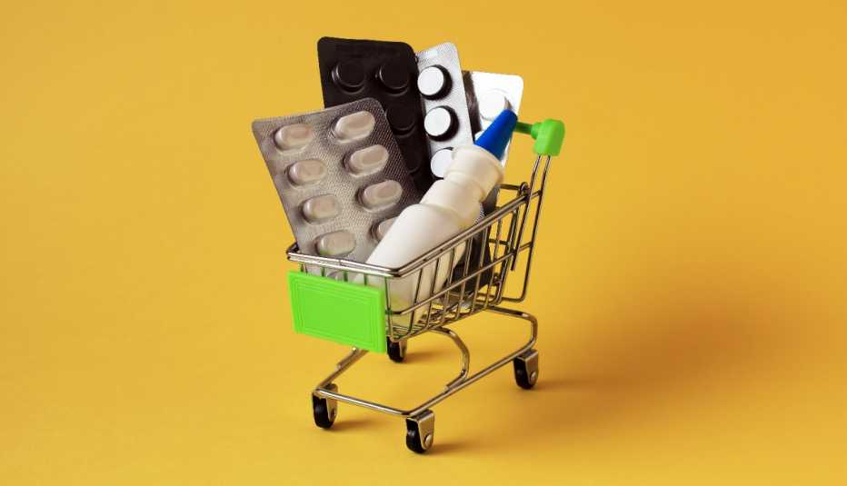 a grocery cart filled with various medicines on a yellow background