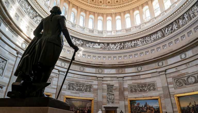 interior of the capitol rotunda inside the dome looking up next to a large statue