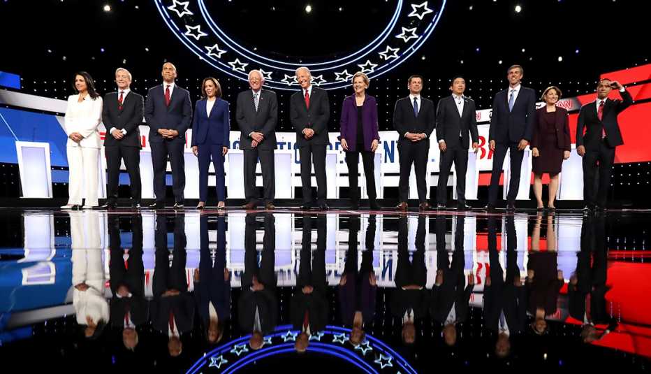 Democratic presidential candidates stand on the stage