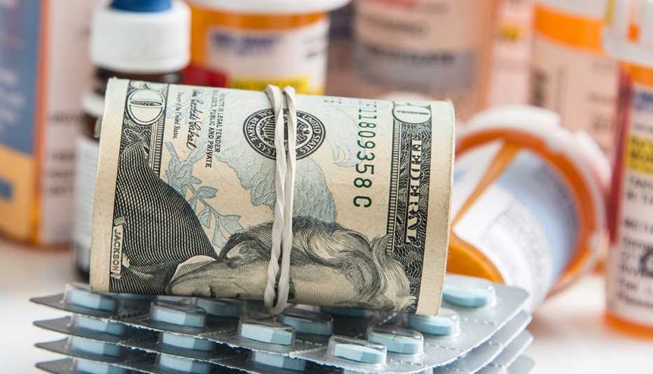 money sitting on top of prescription drugs