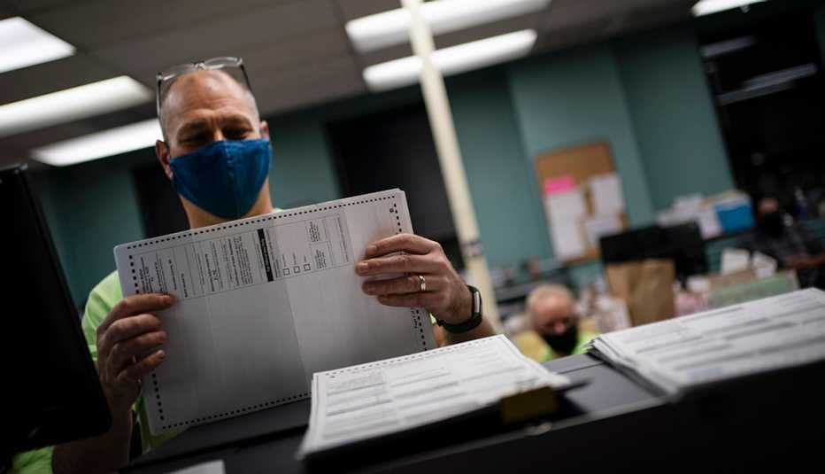 A worker prepares ballots to be counted