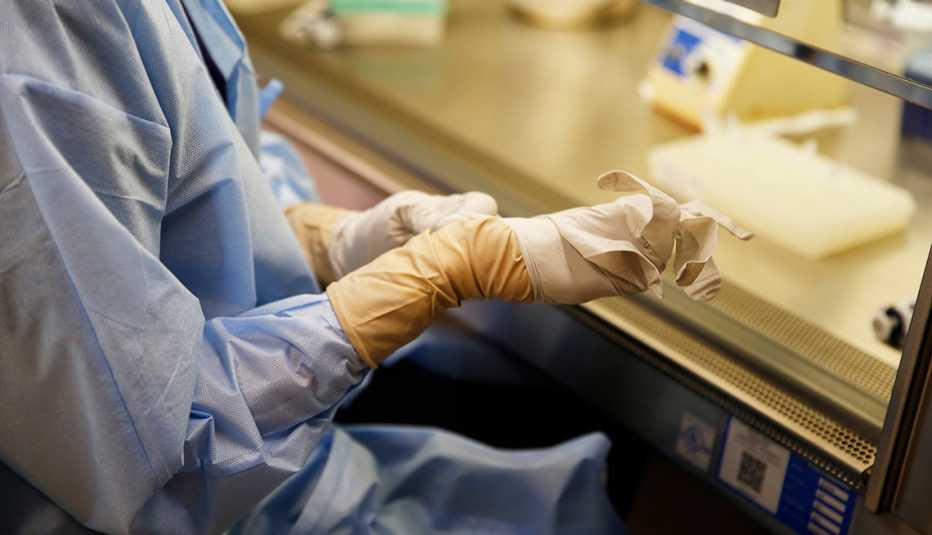 Emily Jacobs, Medical Technologist, changes her gloves at Massachusetts General Hospital in Boston 