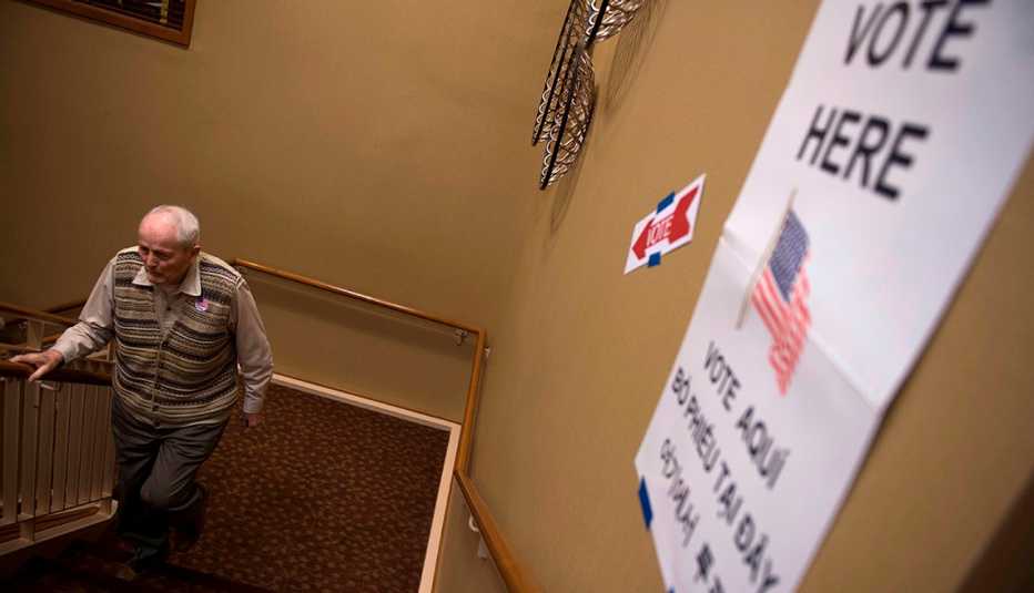 A man walks up stairs to a polling location to vote in an election