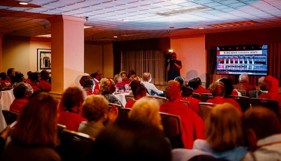 Volunteers wearing red shirts watching the debate in South Carolina