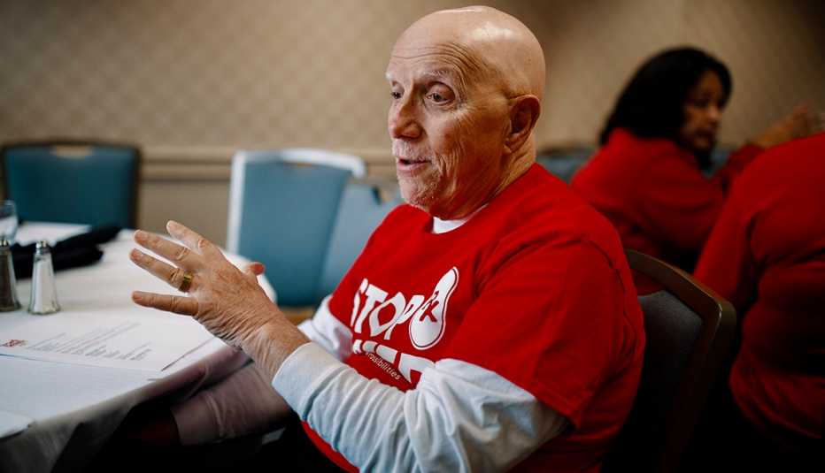 A volunteer in a red shirt sits at a table in South Carolina