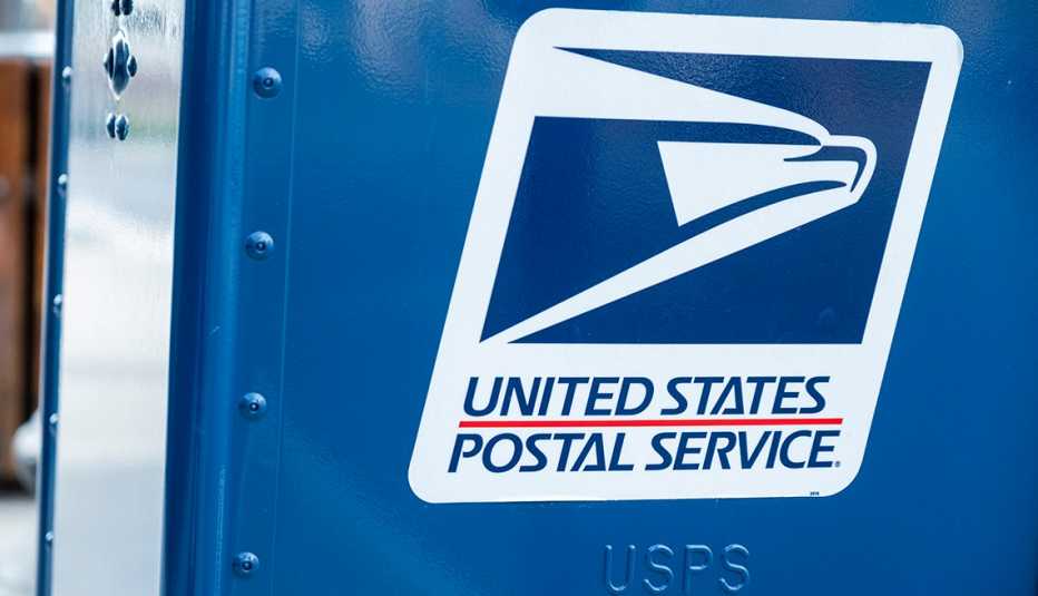 A blue U S P S mail box