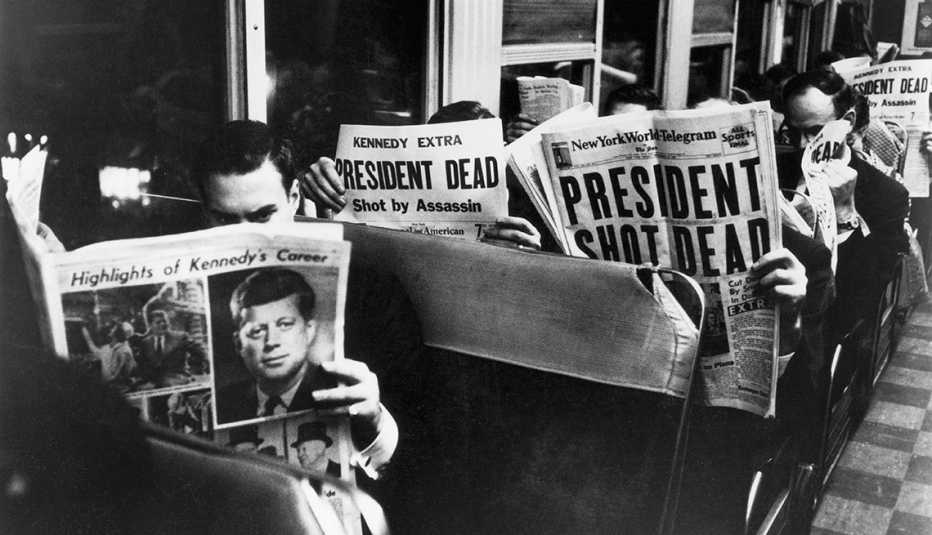 Commuters reading about John F. Kennedy's assassination on Nov. 22, 1963.