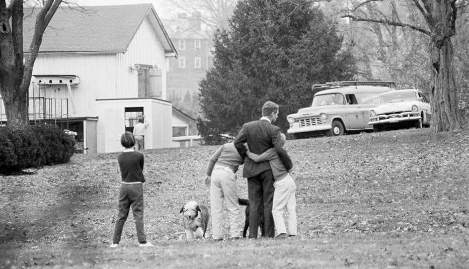 The president's brother, robert kennedy, comforts his children after hearing about J F K's death