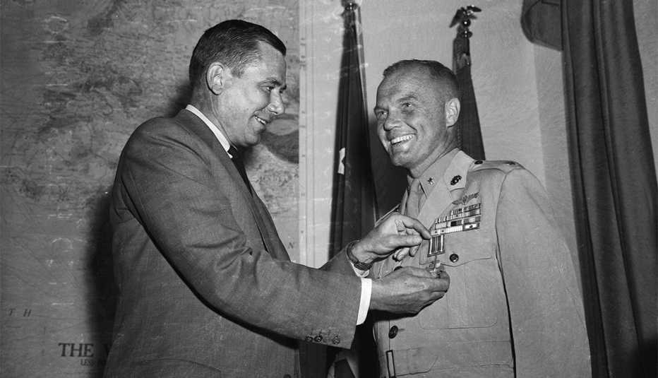 John Glenn receives Distinguished Flying Cross from Navy Secretary Thomas Gates for setting transcontinental speed record in Navy jet