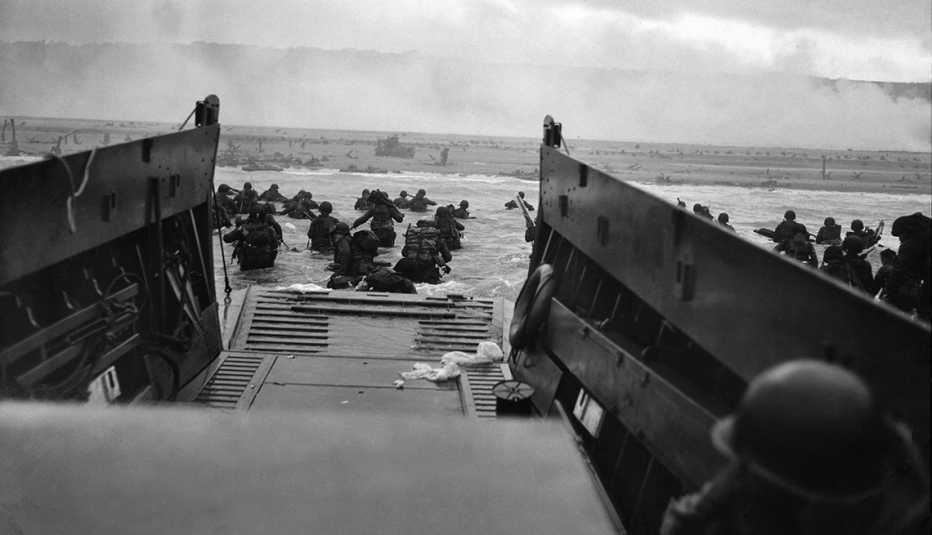 U S troops wading from landing craft towards Omaha Beach