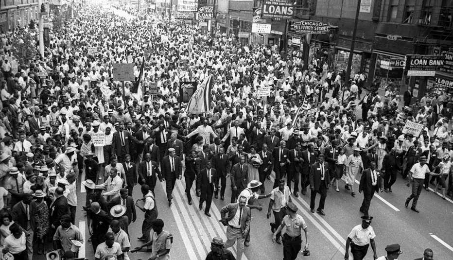 large group marches down city street with martin luther king in chicago