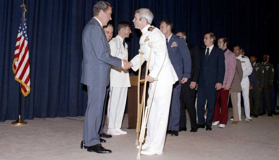 President Richard Nixon shakes hands former North Vietnamese prisoner, Captain John McCain