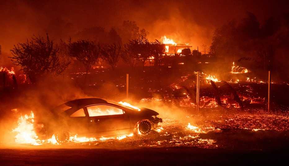 vehicles and homes encased in flames burning on november 8 2018 during the camp fire in paradise ca