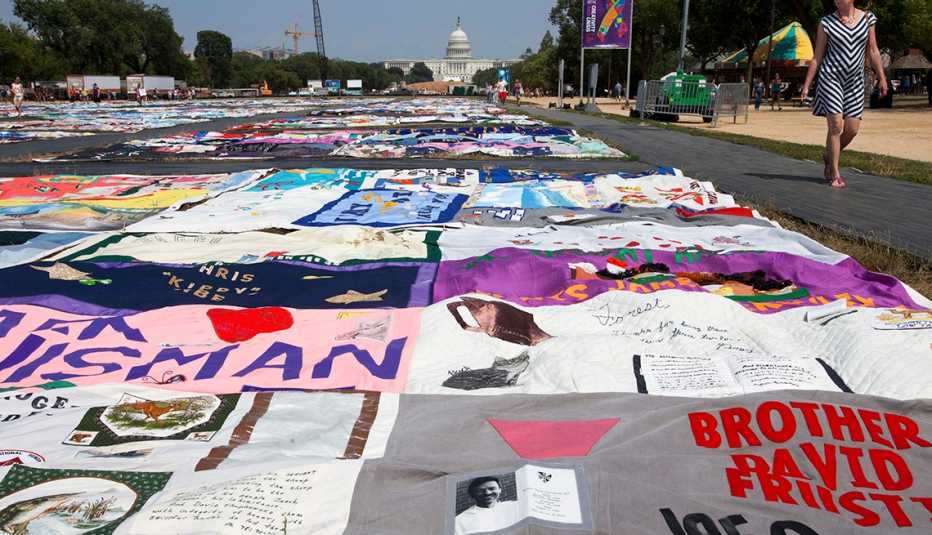 People visit the AIDS Memorial Quilt on display as part of the Smithsonian Folklife Festival on the National Mall in Washington, on Thursday, July 5, 2012. An AIDS-free generation: It seems an audacious goal, considering how the HIV epidemic still is ragi