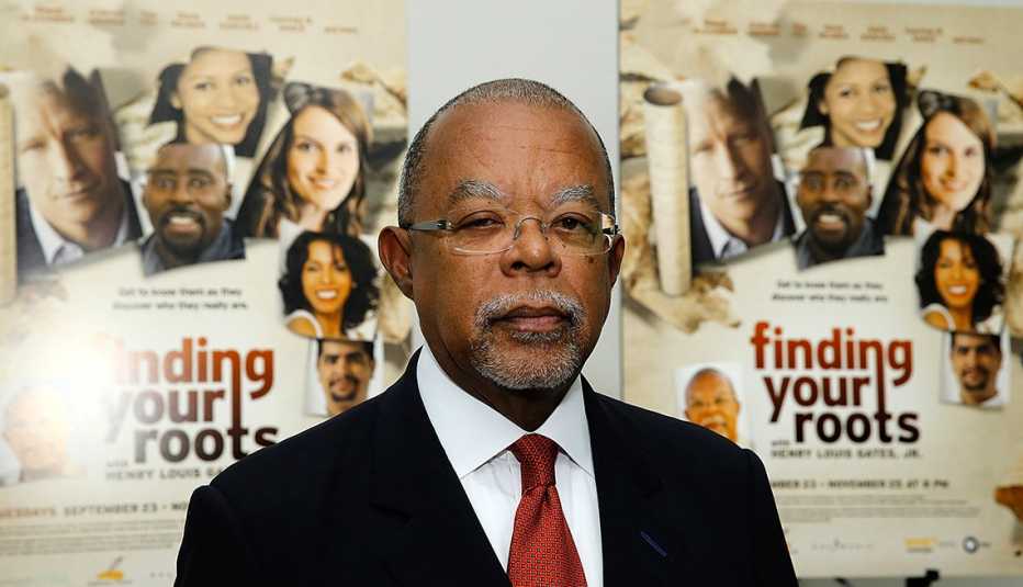Henry Louis Gates Junior stands by two posters of his show finding your roots