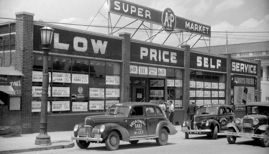 black and white photo from the nineteen forties showing an a and p supermarket store front with cars parked in front