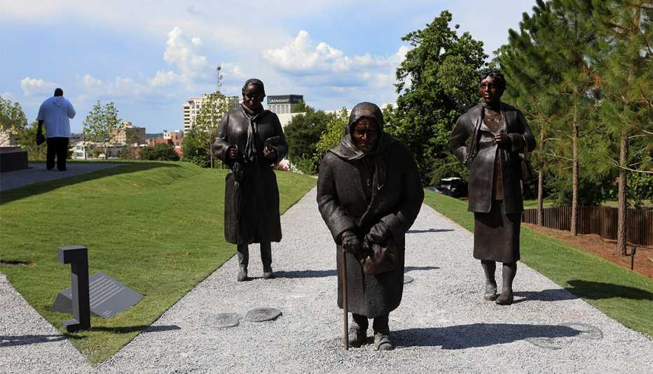 Dana King's 'Guided By Justice' statue, dedicated to black women who sustained the Montgomery Bus Boycott and collectively walked thousands of miles, stands inside The National Memorial For Peace And Justice in Montgomery, Alabama 