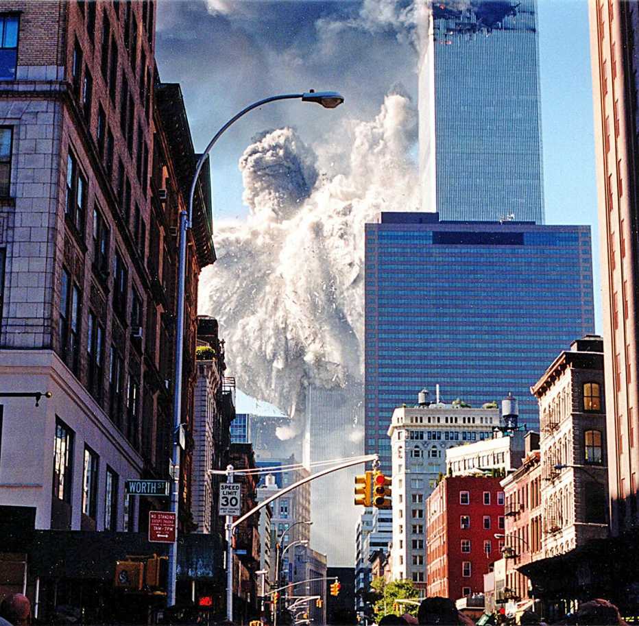 historical photo of the south tower collapsing as seen from blocks away in manhattan