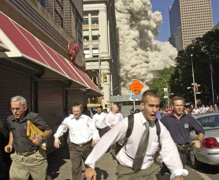 men run from the scene of the world trade center explosions