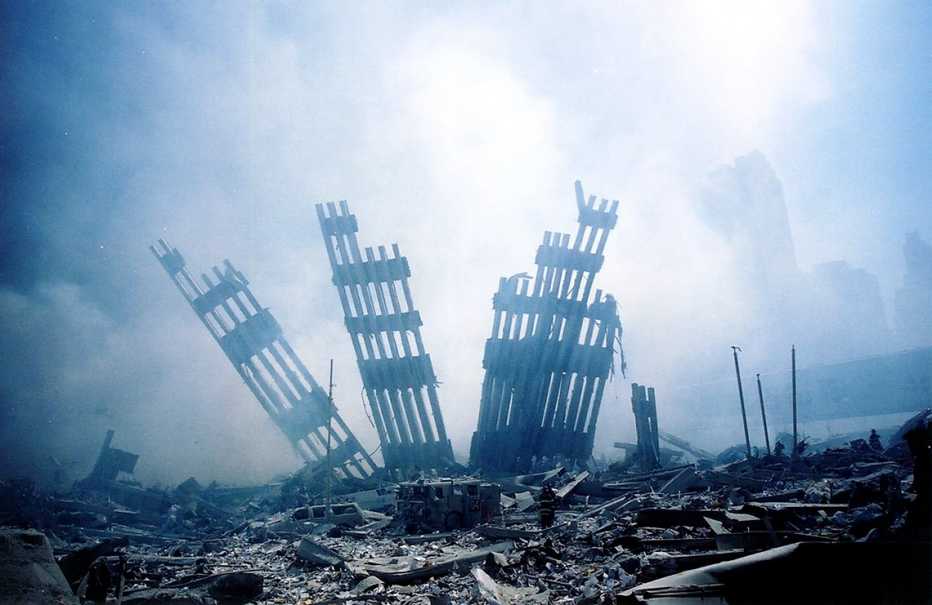 the wreckage of the world trade center is covered in smoke