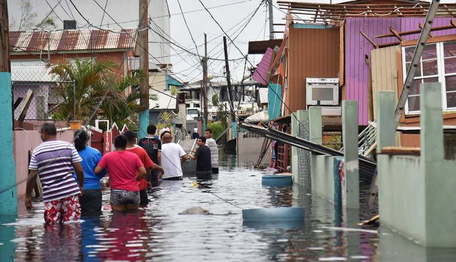 people walking in a flooded street in catano town puerto rico after hurricane maria