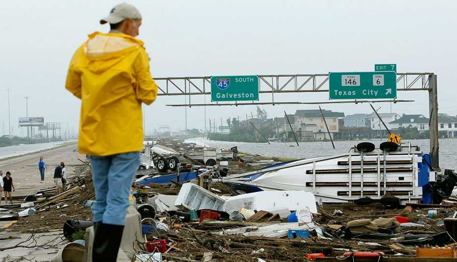 a man inspecting debris on route forty five left by hurricane ike