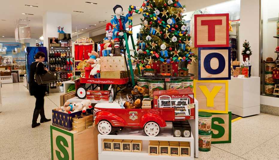 a christmas toy display in a department store that includes a decorated tree a fire engine and toys displayed