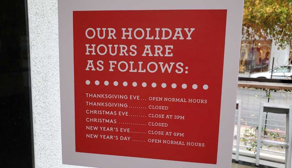 Shop window sign that lists Holiday Shopping hours