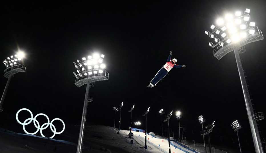 team usa skier megan nick soars into the night sky surrounded by lights while competing in the women’s freestyle skiing aerials event