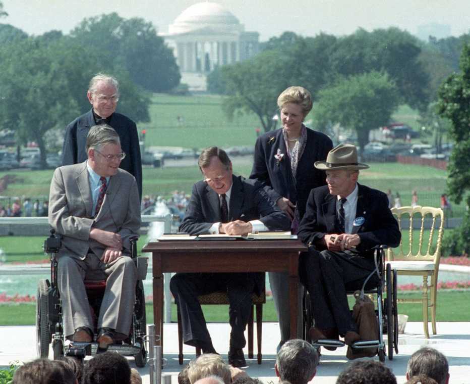president george h w bush signing the americans with disabilities act in july nineteen ninety