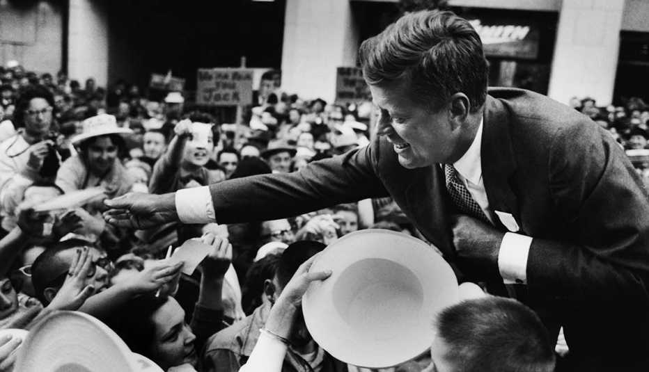 john f kennedy greets a crowd of supporters a year before the presidential election