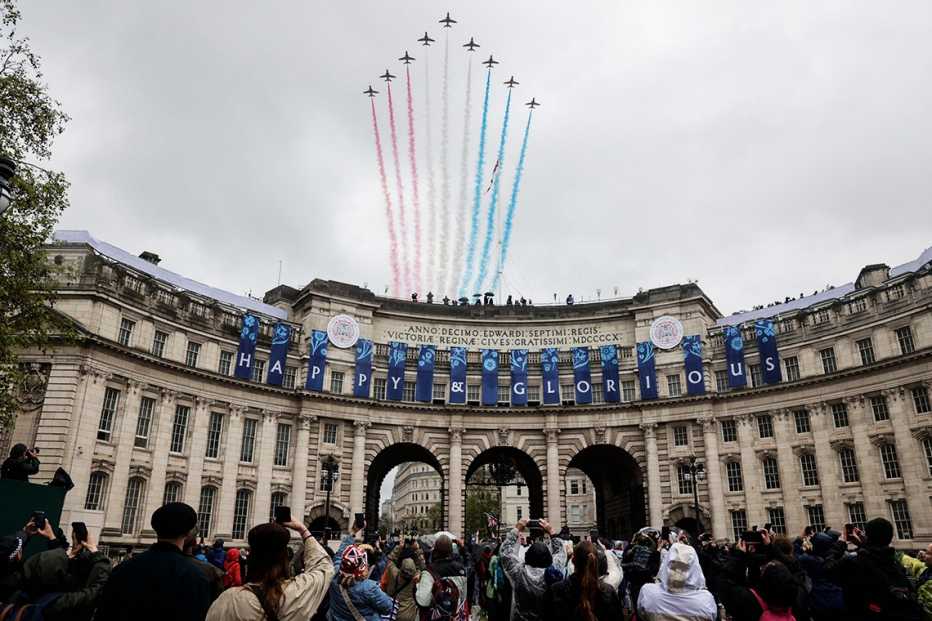 The British Royal Air Force's (RAF) aerobatic team, the "Red Arrows", perform a fly-past over Admiralty Arch after the coronation.