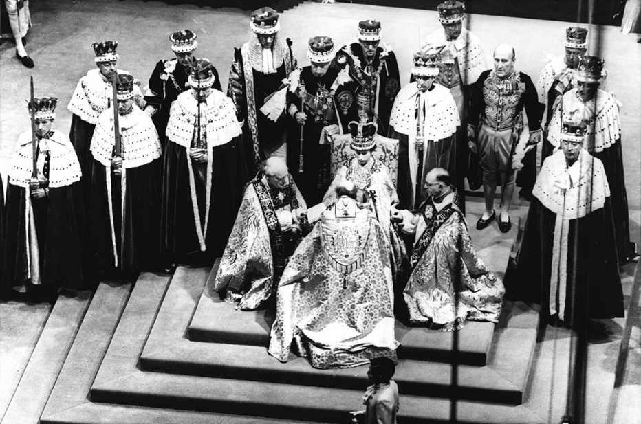 Britain's Queen Elizabeth II, seated on the throne, receives the fealty of the Archbishop of Canterbury, centre with back to camera, the Bishop of Durham, left and the Bishop of Bath and Wells, during her Coronation in Westminster Abbey, June 2, 1953.