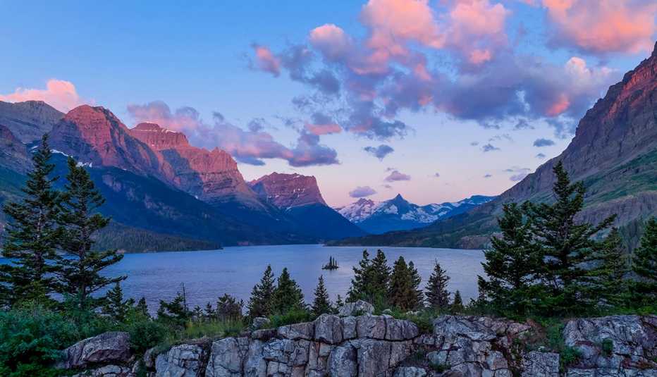 st mary lake in glacier national park is ringed by rocky slopes and trees