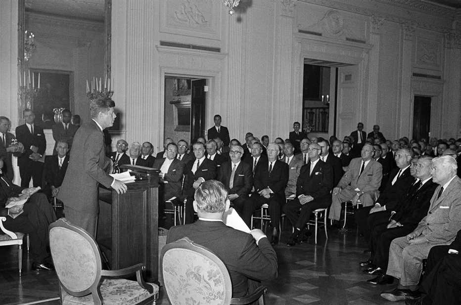 president kennedy speaking to a group in the east room of the white house