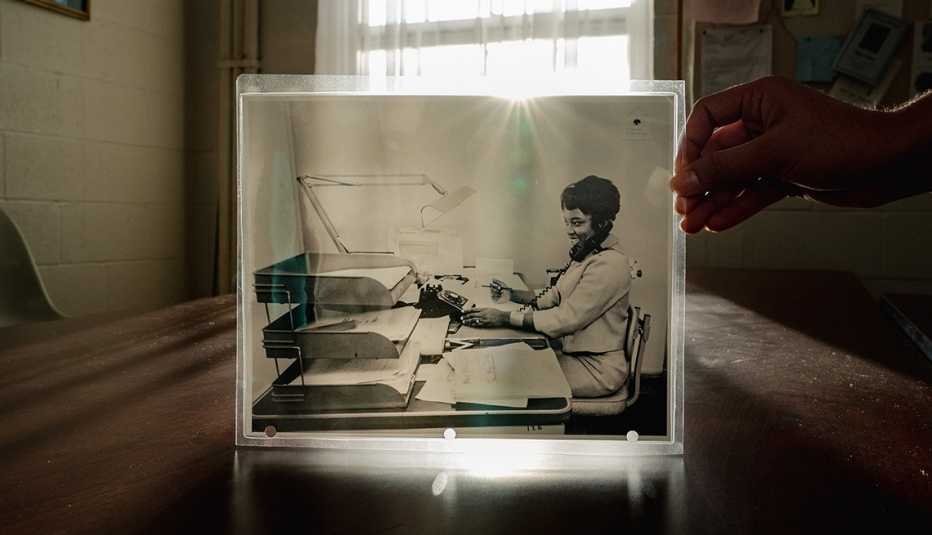 willie pearl mackey king holds up a black and white photo of herself working for doctor martin luther king in nineteen sixty three