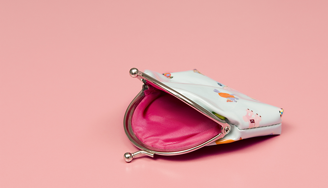 empty coin purse on pink background