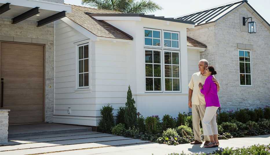 Couple looks at exterior of new home