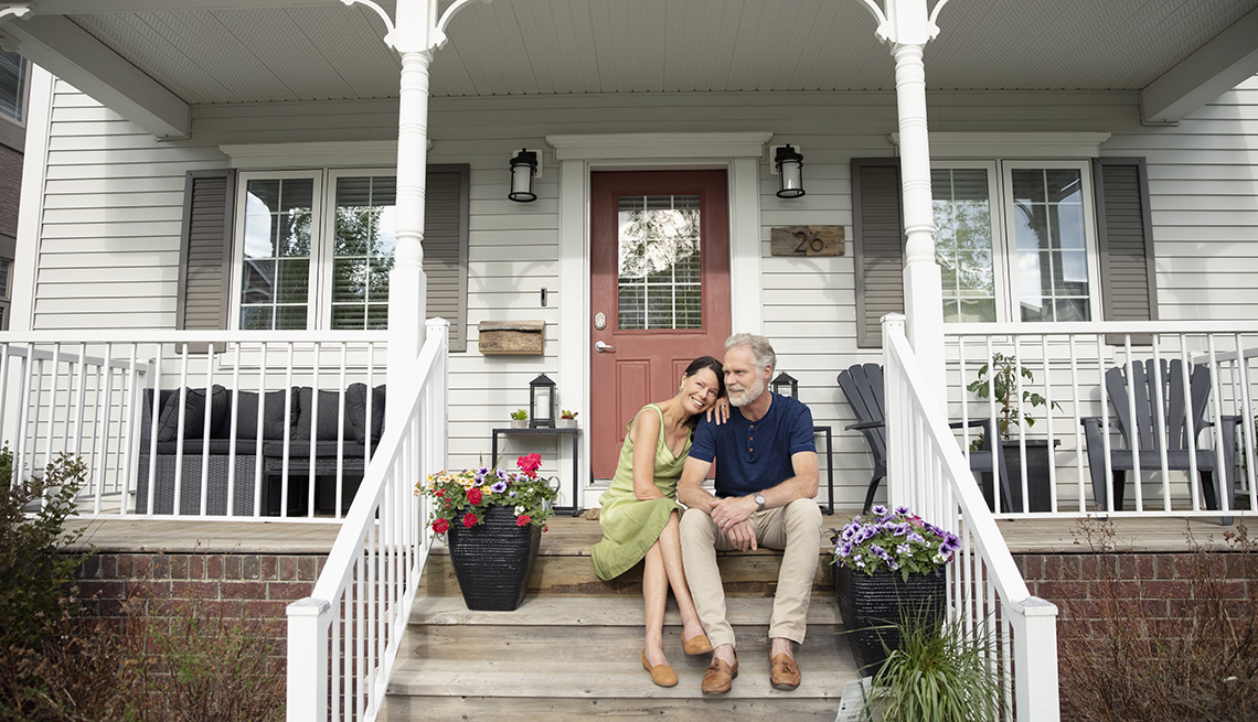 Mature couple sitting on their front porch