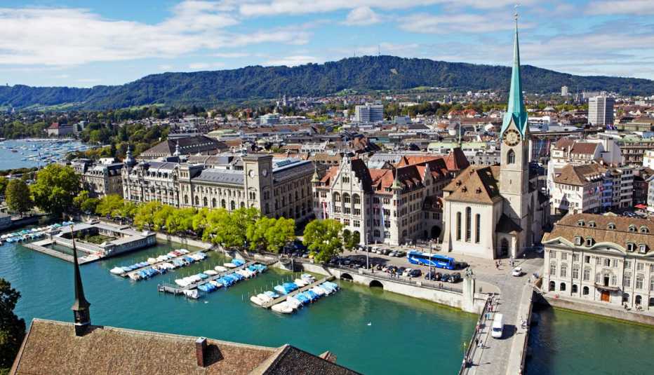skyline of zurich with fraumunster church and river limmat