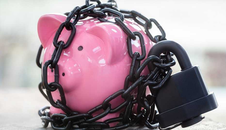 a pink piggy bank is tightly locked up with a heavy padlock and chains