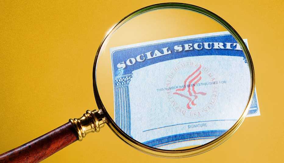 a generic social security card under a magnifying glass on a yellow field