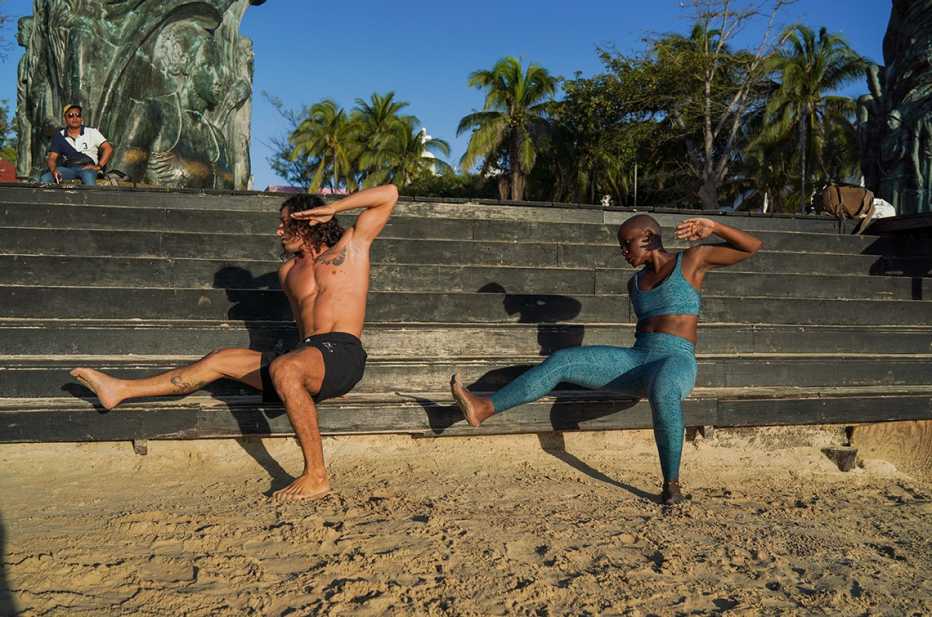 elayne fluker and marcos marchesi working out on the beach