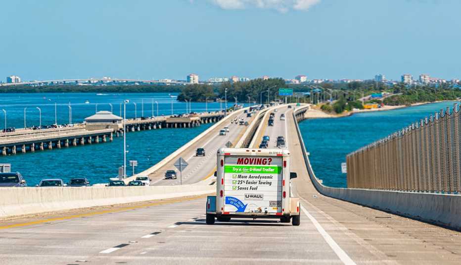 scenic view of a bridge over Tampa Bay, Florida with a Uhaul moving trailer attached to a car