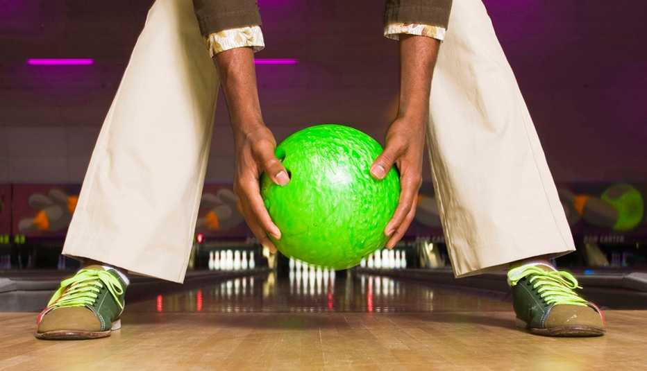 Man Holds Green Bowling Ball, Backwards on Bowling Lane, Lowballed Your Target Salary? Yes, You Can Ask For More