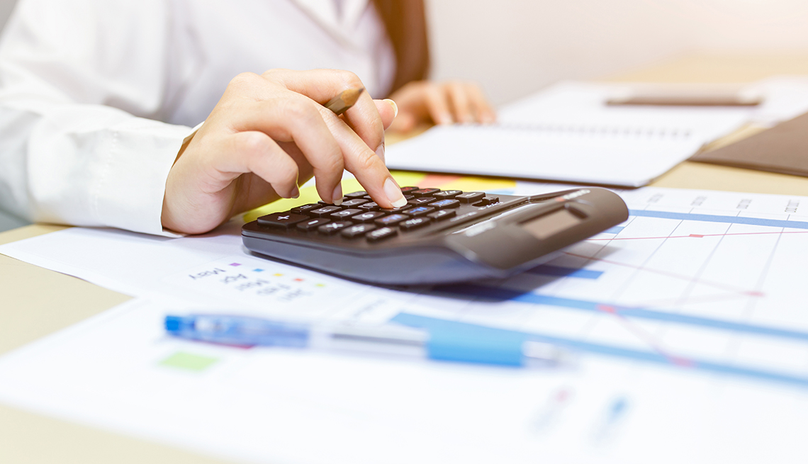 Close up right hand female using calculator, Business or stock market concept image.