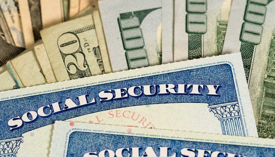 social security cards and hundred dollar bills