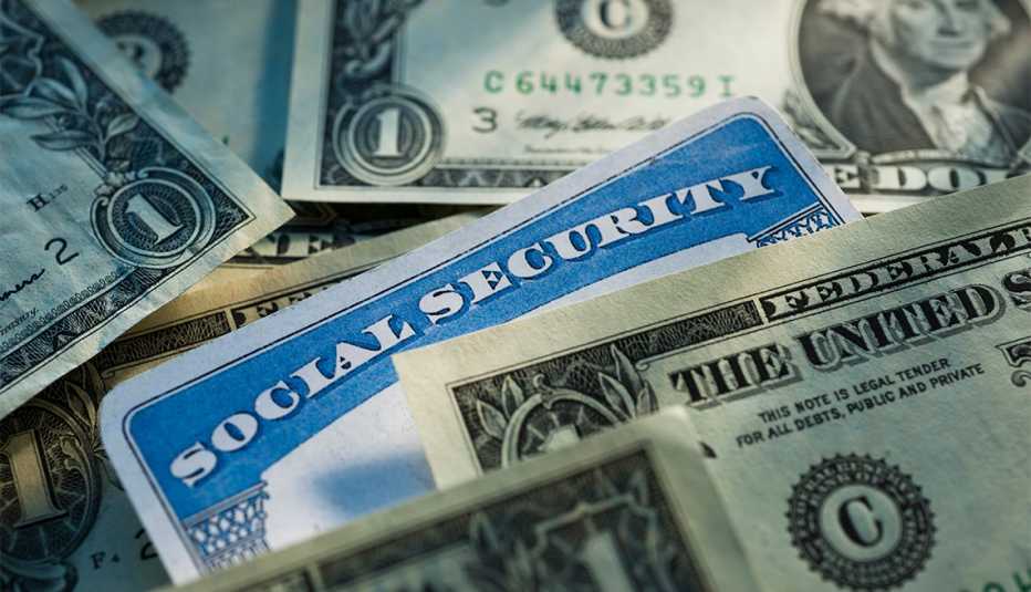 social security card displayed among dollar bills
