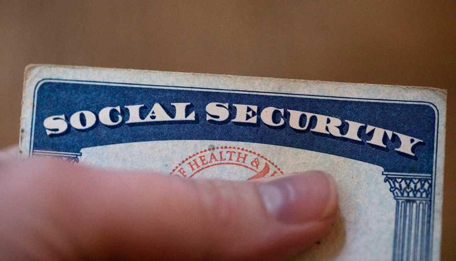 a hand is holding a social security card